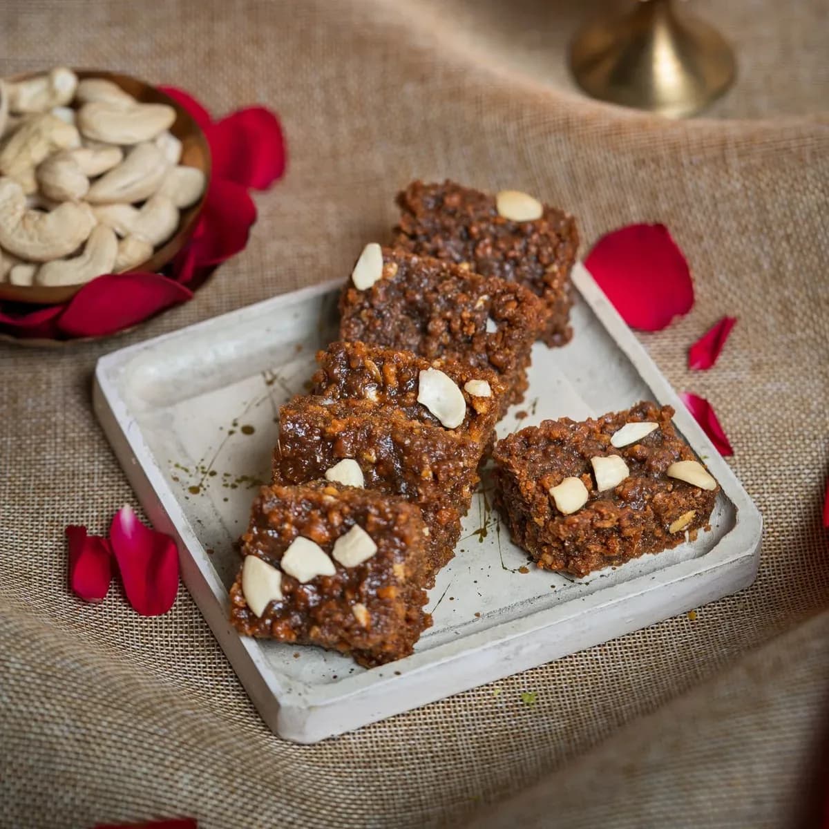 Dark, grainy doda barfi topped with almonds
