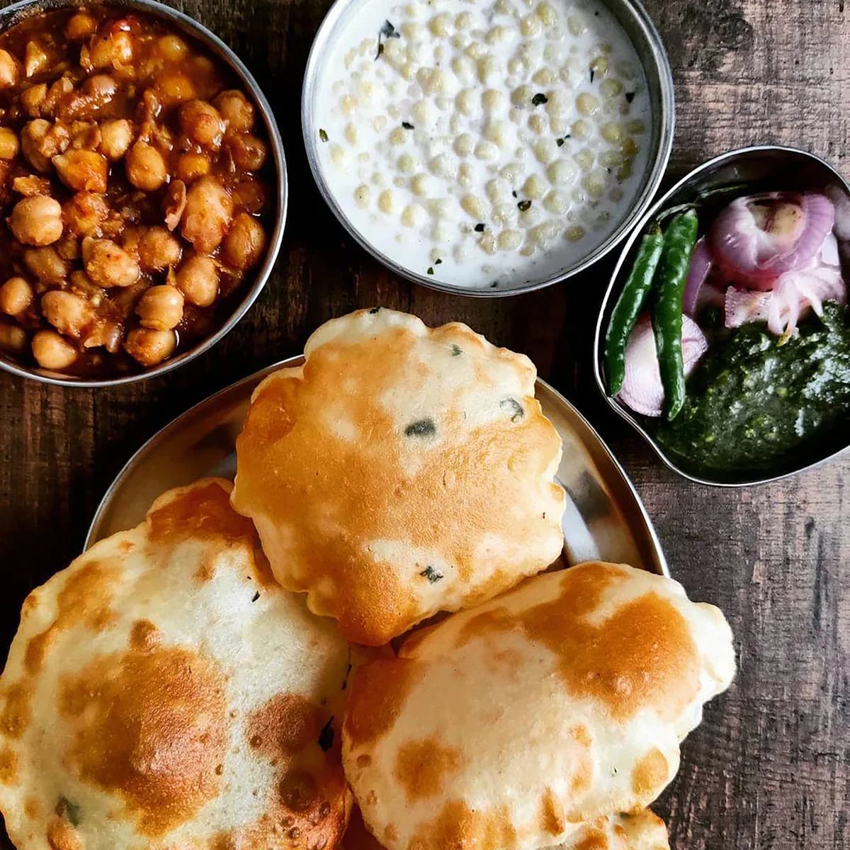 Khasta kachori served with spiced chana and raita