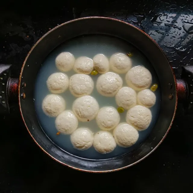 Soft white sponge rasgulla floating in syrup