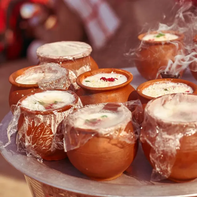 Sweet lassi topped with malai in clay kulhads