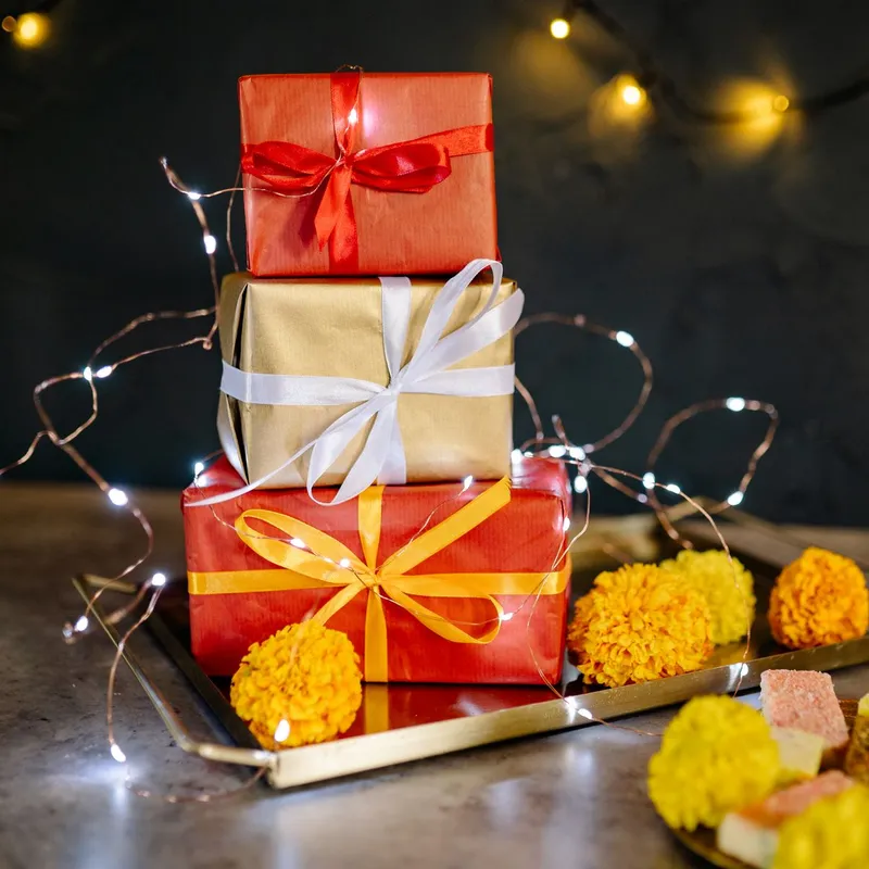 Stacked gift boxes with marigolds