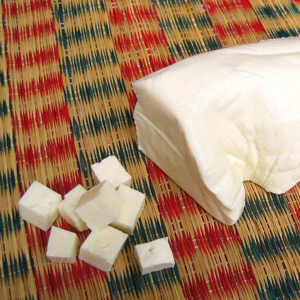A fresh block of soft white paneer with a few cut cubes